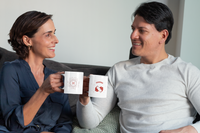 jeune couple qui sourit avec un Mug Constellation Poissons en céramique dans les mains